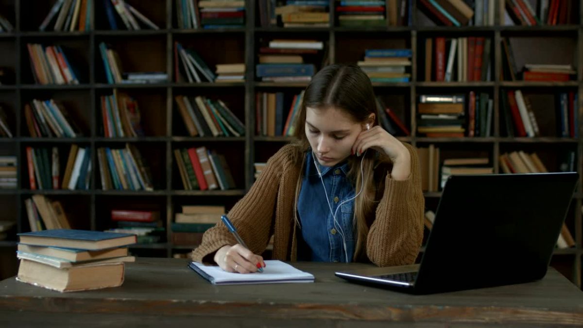 Girl Doing Homework In A Library 4531 Medium