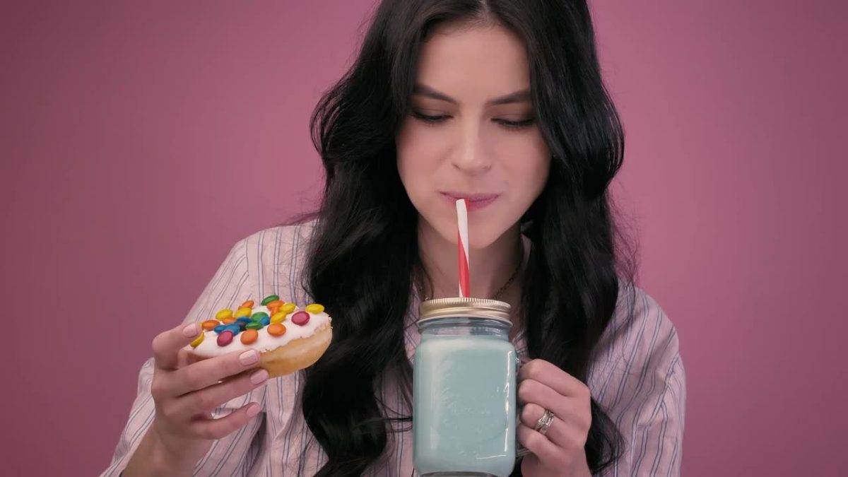 Girl Eating A Glazed Donut With A Milkshake 40831 Medium